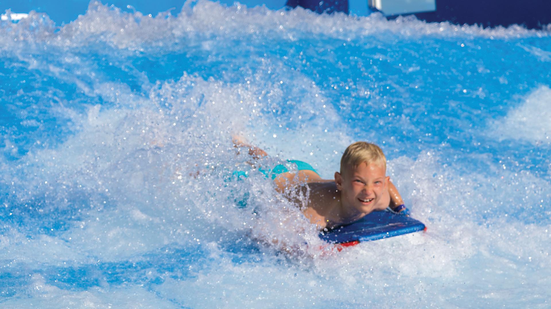harmony-of-the-seas-flowrider-boy-body-surfing-laughing